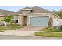 Attractive one-story home featuring a brick-paved driveway leading to a two-car garage at 4763 Riverwalk Dr, St Cloud, FL 34771