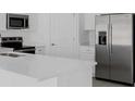 Bright kitchen with quartz counters, stainless appliances, and modern white cabinetry at 1931 Rosewood Cir, Lakeland, FL 33810