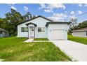 Beautiful home with a manicured lawn, modern design, and inviting curb appeal at 2216 W Lanier St, Lakeland, FL 33815