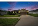 Inviting single-story home with a lush green lawn, a wide driveway, and an attached garage at 139 Sunfish Dr, Winter Haven, FL 33881