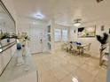 Elegant dining room with modern tile, stylish lighting, and a sleek white dining set at 2480 Brownwood Dr, Mulberry, FL 33860