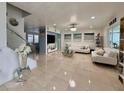 Spacious living room features modern tile flooring, a large television, and elegant white furniture at 2480 Brownwood Dr, Mulberry, FL 33860