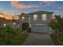 Charming two-story home with a well-maintained lawn during the sunset at 913 Parasol Pl, Kissimmee, FL 34759