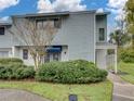 Charming townhouse features a well-maintained lawn and beautiful shrubbery enhancing its curb appeal at 222 Carpenters Way # 9, Lakeland, FL 33805