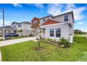 Beautiful home with a well-kept lawn, landscaping, and partial pond view in a desirable neighborhood at 4381 Pumice Dr, Lakeland, FL 33811