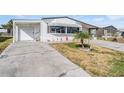 Charming single-story home featuring a well-maintained yard at 5006 Lodgewood Dr, Lakeland, FL 33810