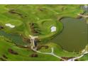 Picturesque aerial view of a lush green golf course with winding paths, ponds, and footbridges on a sunny day at 6922 Wendy Way, The Villages, FL 34762