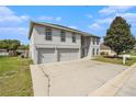 Attractive two-story home with a spacious driveway, a two-car garage and arched windows at 6087 Sunset Vista Dr, Lakeland, FL 33812
