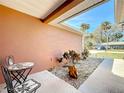 Inviting outdoor seating area with a small table, chairs, and landscaping detail providing a cozy place to relax at 703 New York Ave, South Daytona, FL 32119