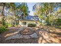 Exterior of the two-story home with a deck, showcasing the lush greenery and spacious backyard at 9401 Cat Track Trl, Lake Wales, FL 33898