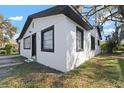 A bright white, single story home featuring dark window trim and a new roof at 1104 W 9Th St, Lakeland, FL 33805