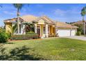 Charming single-story home with tile roof, well-manicured lawn and lush landscaping with a convenient two car garage at 11321 Ledgement Ln, Windermere, FL 34786