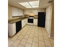 Well-lit kitchen featuring white cabinets, granite countertops, and black appliances at 1424 Ridge Lake Ct, Lakeland, FL 33801