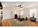 Cozy living room features neutral walls, ceiling fan, and wood laminate flooring at 14285 Oconner Rd, Kathleen, FL 33849
