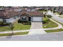 Inviting single Gathering home featuring neutral colors, tile roof, and landscaped front yard at 168 Claffey Ct, Haines City, FL 33844