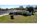 Well-kept, single-story home with beautiful landscaping, a brick facade, and a neatly manicured lawn at 1743 Wilshire Ct, Lakeland, FL 33813