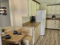 Bright eat-in kitchen featuring a booth, white appliances, and plenty of cabinet storage at 4836 Goldenview Ln, Lakeland, FL 33811