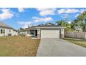 Charming single-story home with a well-maintained lawn and a two-car garage at 420 Tecumseh N Ave, Fort Meade, FL 33841