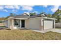 A single-story home featuring an attached two-car garage and a well-manicured front lawn at 420 Tecumseh N Ave, Fort Meade, FL 33841