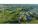 Golf course community featuring single-story homes with a picturesque setting, complemented by well-maintained landscaping at 1717 Lilly Ln, Lady Lake, FL 32159