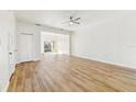 Bright living room featuring wood floors, ceiling fan, and lots of natural light at 2938 Rodrick Cir, Orlando, FL 32824