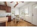 Bright eat-in kitchen features a glass table, wood floors, and a view of the backyard at 3925 Ne 92Nd Pl, Anthony, FL 32617