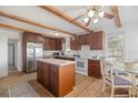 Spacious kitchen with dark wood cabinets, stainless steel appliances, and wood flooring at 3925 Ne 92Nd Pl, Anthony, FL 32617