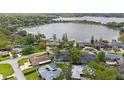 Stunning aerial view of lakeside homes, featuring beautiful landscaping and a serene lake backdrop at 12 Lake Link Dr, Winter Haven, FL 33884