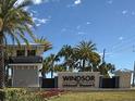 Windsor Island Resort entrance sign framed by palm trees and well-maintained landscaping at 627 Jasmine Ln, Davenport, FL 33897