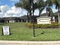 View of the Viareggio community entrance sign amidst lush landscaping and well-maintained homes, promising an inviting neighborhood at 2188 Palm Tree Dr, Kissimmee, FL 34759