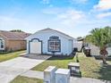 Well-maintained single-story home featuring a concrete driveway and manicured lawn at 2506 Hadleigh St, Kissimmee, FL 34743