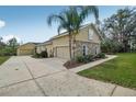 This home features a spacious driveway leading to attached and detached garages at 6327 Ashley Dr, Lakeland, FL 33813
