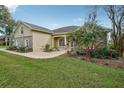 Well-maintained one-story home with stone accents, arched windows, and lush landscaping at 6327 Ashley Dr, Lakeland, FL 33813