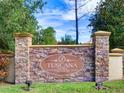 Stone welcome sign for the community featuring the name and Mediterranean styling at 8010 Tuscany Way # 5301, Davenport, FL 33896