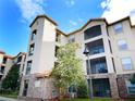 Angle view of condominium with multiple balconies, stone accents and manicured landscaping at 8010 Tuscany Way # 5301, Davenport, FL 33896