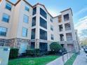 Low angle view of condominium with stone accents, multiple balconies and landscaping at 8010 Tuscany Way # 5301, Davenport, FL 33896