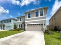 Well-maintained two-story home with a two-car garage and a manicured lawn at 8923 Sw 50Th Ave, Ocala, FL 34476