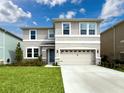 Charming two-story home featuring a two-car garage and manicured front lawn at 8923 Sw 50Th Ave, Ocala, FL 34476