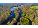 Scenic aerial view of a winding river surrounded by lush green forests at 4942 Cr 300, Lake Panasoffkee, FL 33538