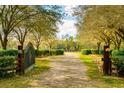 Private gated entrance with a long driveway leading to the property at 4942 Cr 300, Lake Panasoffkee, FL 33538