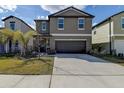 Charming home featuring a well-maintained lawn and concrete driveway at 2244 Teneroc Trl, Lakeland, FL 33805