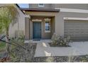 Inviting front porch featuring a stylish blue door and manicured landscaping at 2244 Teneroc Trl, Lakeland, FL 33805