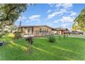 Well-maintained home with a green lawn, an American flag and a convenient carport at 520 S Orange Ave, Fort Meade, FL 33841