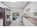 Modern kitchen featuring stainless steel appliances, white cabinetry, and granite countertops at 1126 Waterview E Blvd, Lakeland, FL 33801