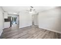 Bright living room featuring new flooring and a ceiling fan at 1126 Waterview E Blvd, Lakeland, FL 33801