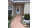 Charming front porch with decorative plants and a path, creating a welcoming entrance at 3105 Carrollton Ct, The Villages, FL 32162