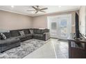 Cozy living room showcasing a comfortable sectional, stylish rug, and french doors that lead to the exterior at 915 E Lake Parker Dr, Lakeland, FL 33801