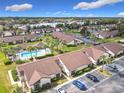 Aerial view of a community with a refreshing pool, green spaces, and ample parking at 101 Grand Plaza Dr. # P-3, Orange City, FL 32763