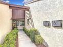 Welcoming entrance with well-manicured hedges, charming details, and a pathway at 101 Grand Plaza Dr. # P-3, Orange City, FL 32763
