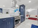 This modern kitchen boasts stainless steel appliances, marble countertops, and blue cabinetry at 226 Selkirk Way, Longwood, FL 32779